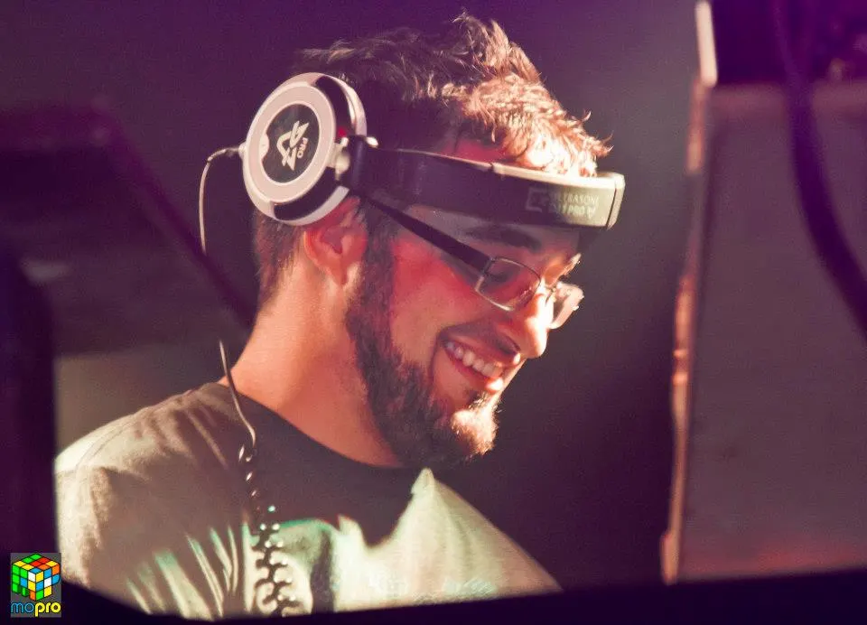 MontsDe smiling in headphones and glasses at a DJ event