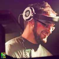 Smiling DJ in headphones and glasses at an event